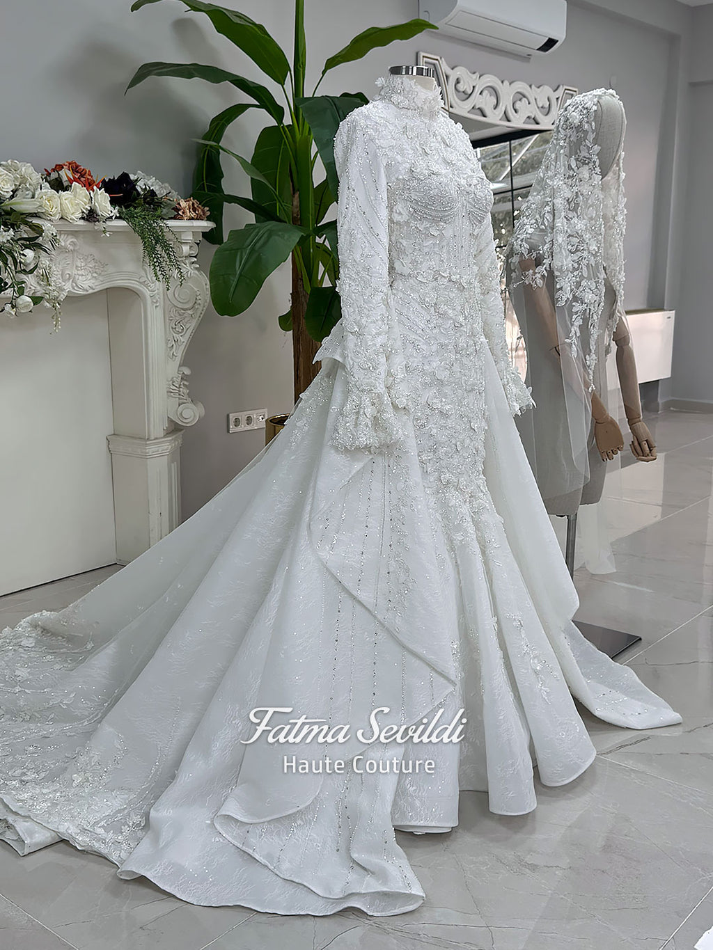 3-in-1 white hijab wedding dress with a beaded mermaid gown, detachable overskirt and long sleeve high-neck bridal topper. Convertible modest bridal set with dimensional floral lace and a coordinating lace veil.