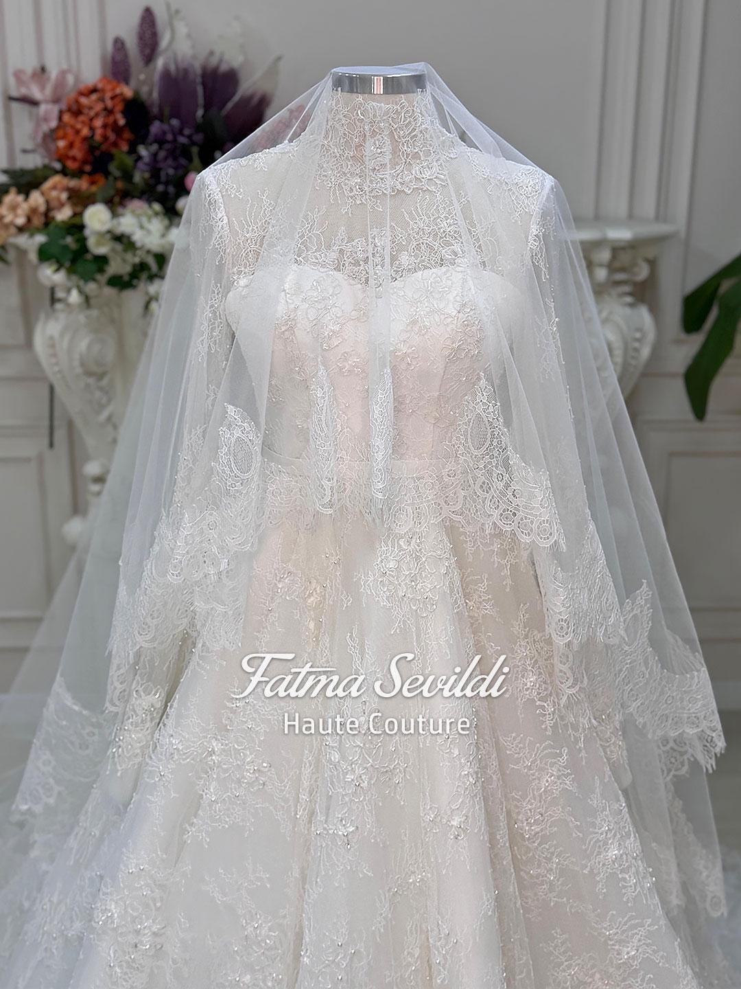 Elegant strapless lace wedding gown with beaded French lace, corset back and veil