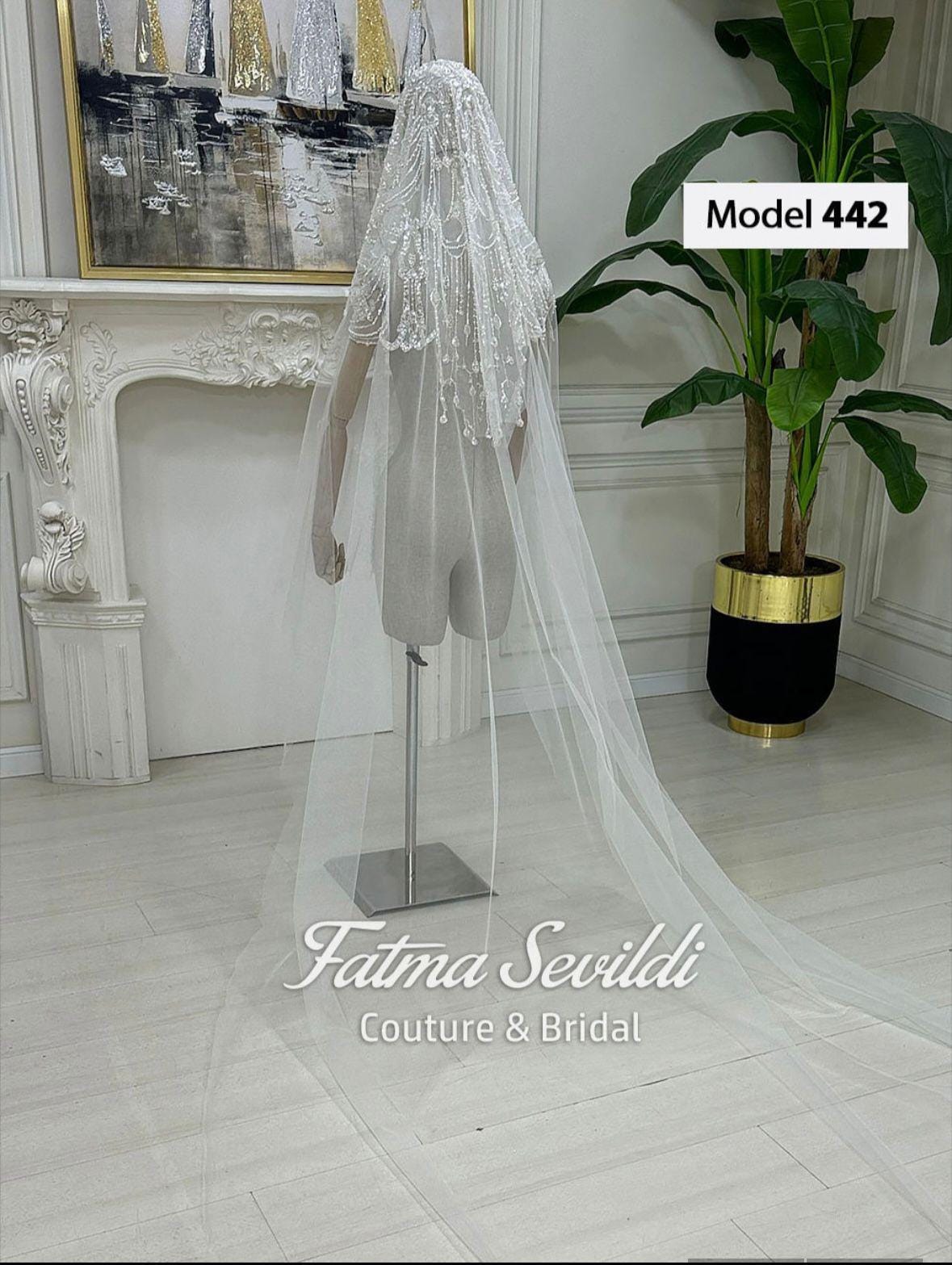 Delicate white beaded Muslim bridal veil with lace details and train