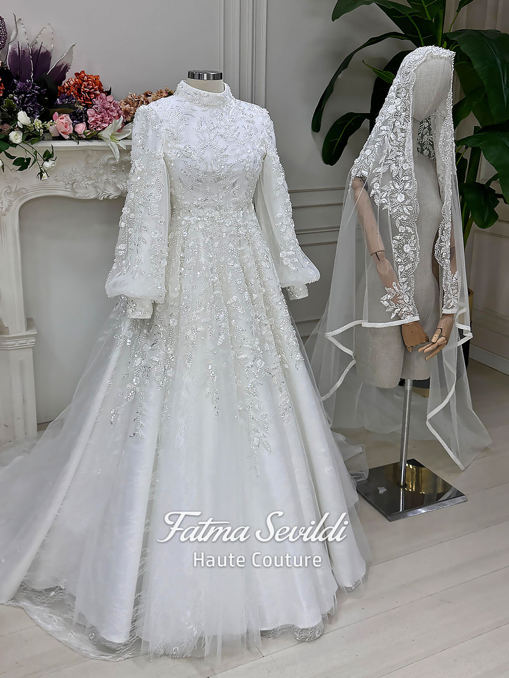 Luxury Muslim wedding dress with high neck, long sleeves, beaded lace embroidery, full A-line skirt, and matching premium lace veil. Elegant modest bridal gown custom made for hijab brides seeking a couture wedding look.