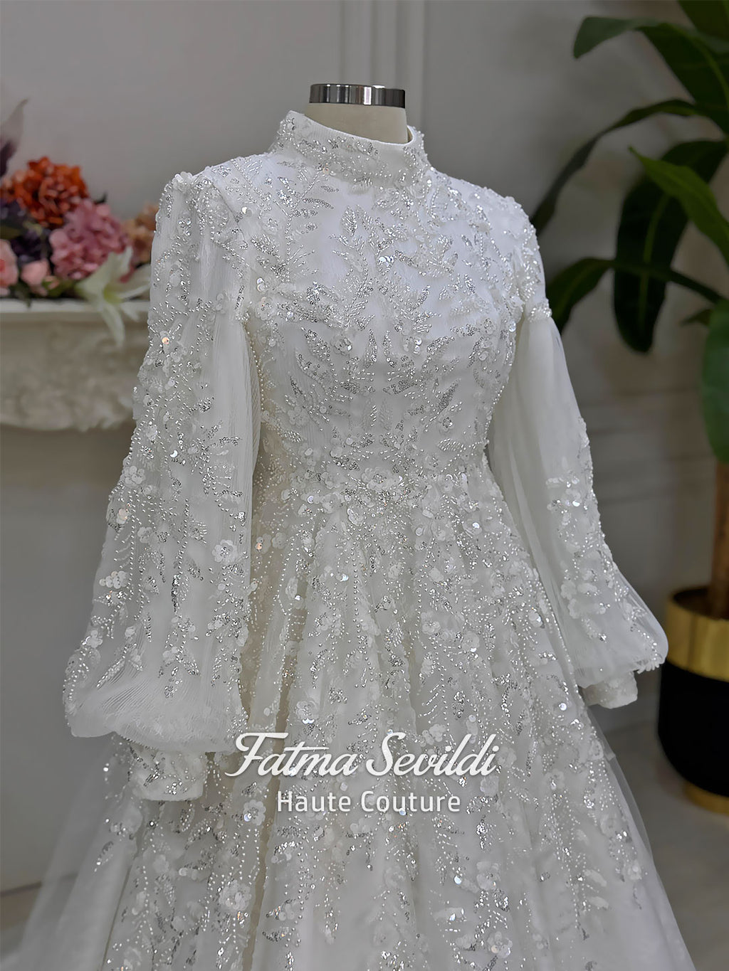 Luxury Muslim wedding dress with high neck, long sleeves, beaded lace embroidery, full A-line skirt, and matching premium lace veil. Elegant modest bridal gown custom made for hijab brides seeking a couture wedding look.