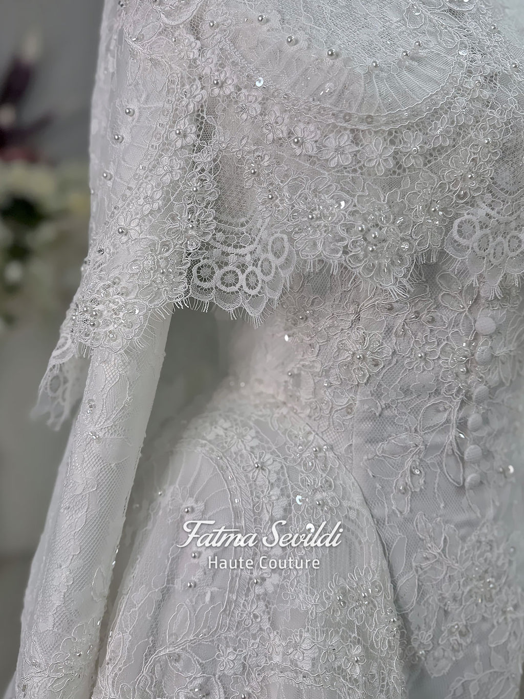 Off-white hijab wedding dress by Fatma Sevildi with beaded floral lace, a basque waist, long sleeves and a high neckline.