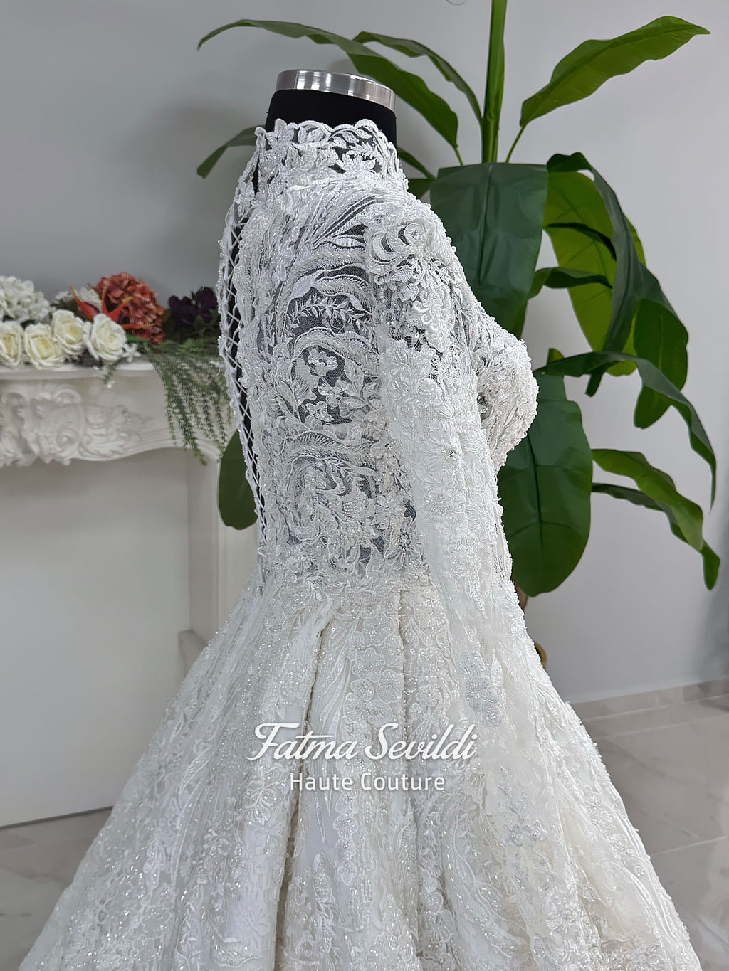 Ivory luxury hijab wedding dress featuring long lace sleeves, a high neckline, full beaded floral lace princess skirt, dramatic train and coordinating premium lace veil.