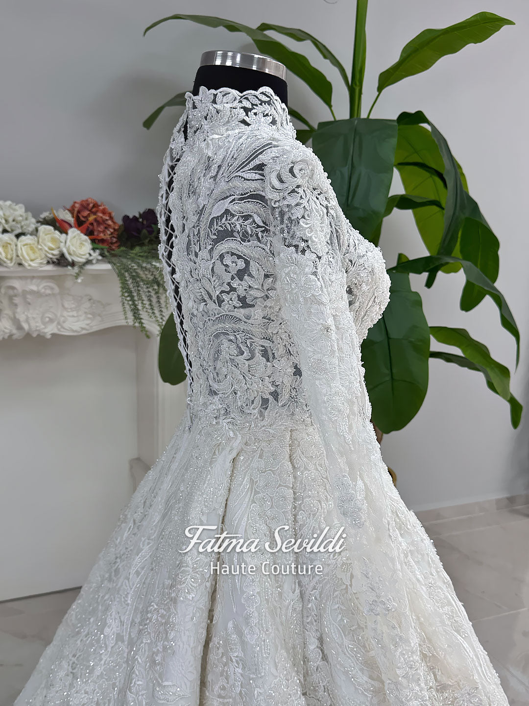 Ivory luxury hijab wedding dress featuring long lace sleeves, a high neckline, full beaded floral lace princess skirt, dramatic train and coordinating premium lace veil.