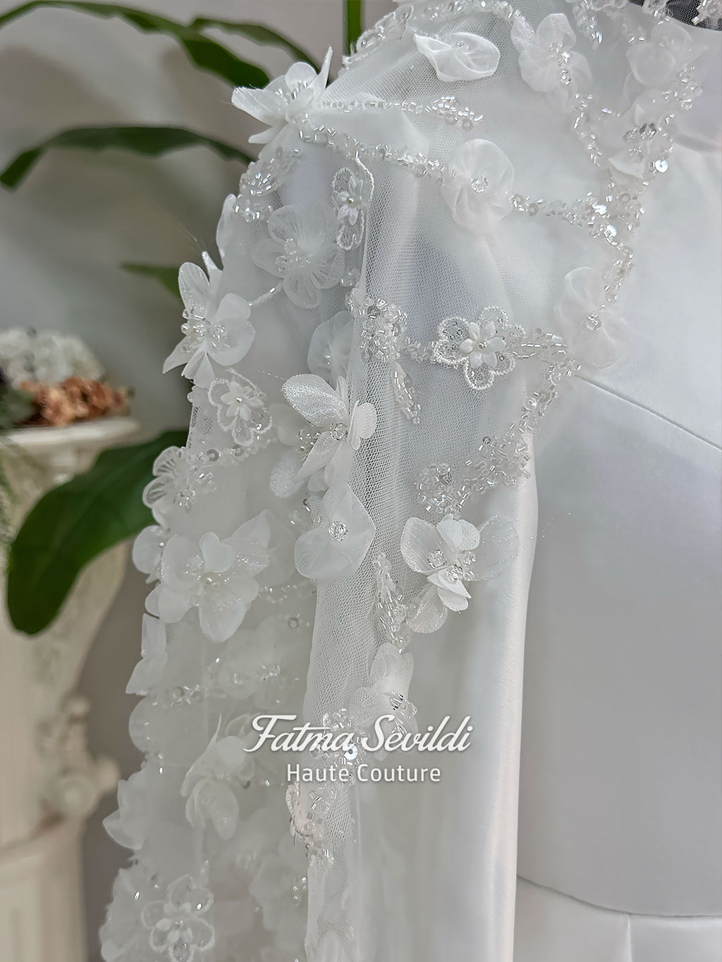 Luxury hijab wedding dress with long sleeves and high neck in an elegant A-line silhouette, shown with premium lace veil. Modest bridal gown featuring subtle sparkle embroidery and a chapel train.