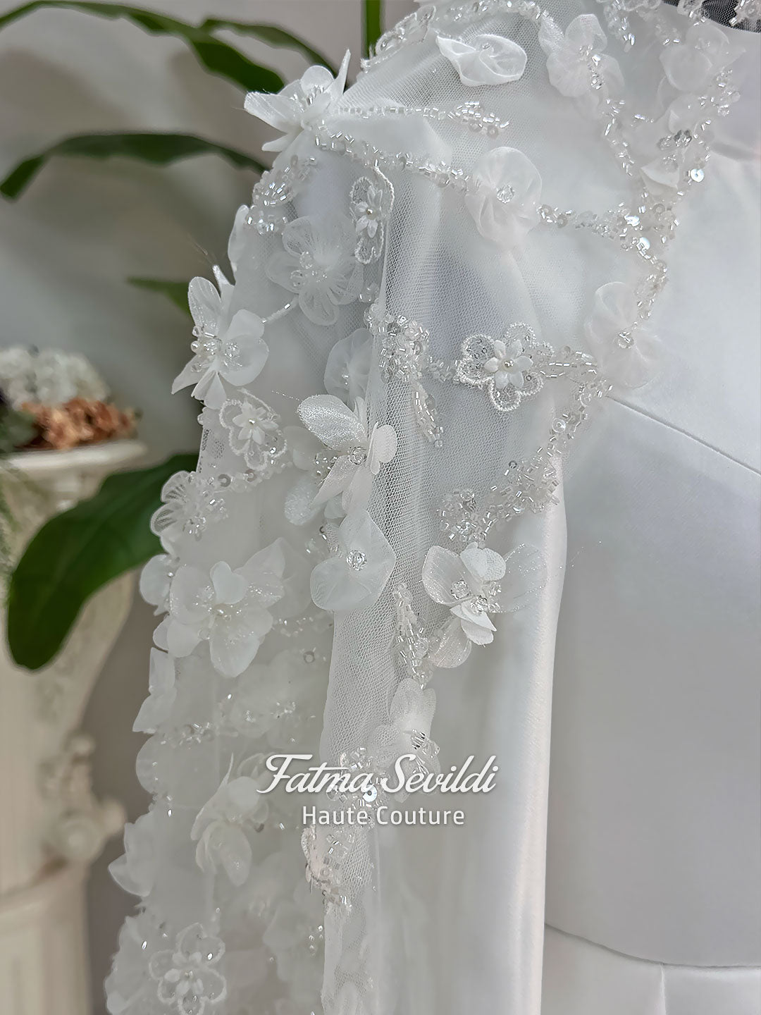 Luxury hijab wedding dress with long sleeves and high neck in an elegant A-line silhouette, shown with premium lace veil. Modest bridal gown featuring subtle sparkle embroidery and a chapel train.