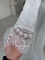 Off-white hijab wedding dress by Fatma Sevildi with beaded floral lace, a basque waist, long sleeves and a high neckline.