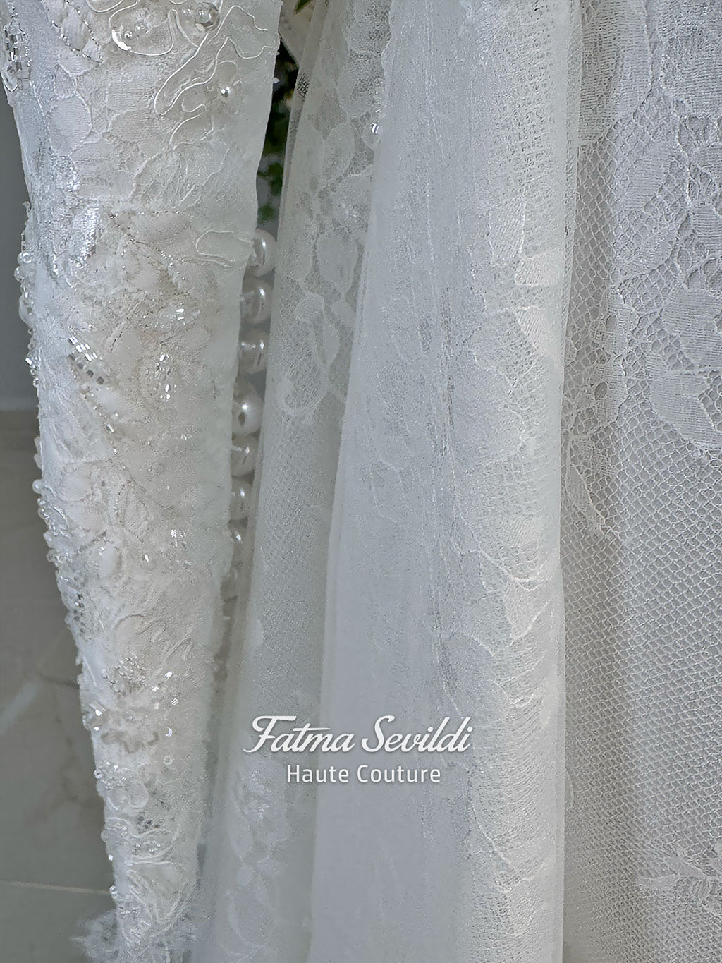 Luxury hijab wedding dress with long sleeves, high mock neck, floral lace embroidery, detachable mermaid skirt, dramatic train and premium lace veil for a modest Muslim bride.