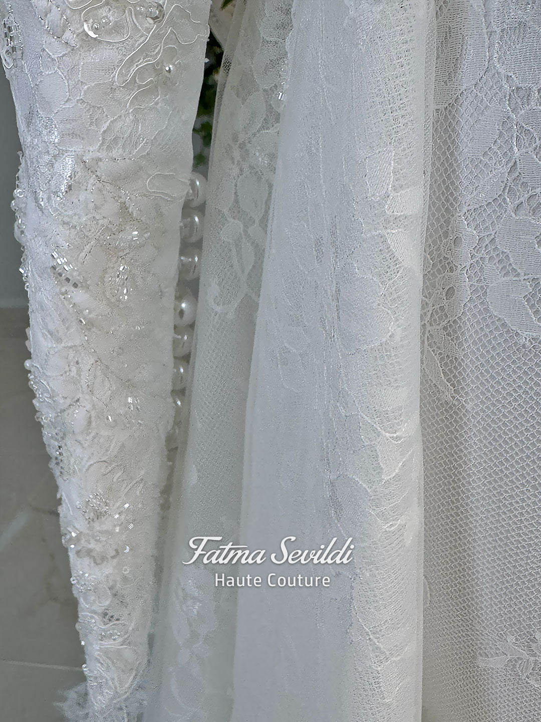 Luxury hijab wedding dress with long sleeves, high mock neck, floral lace embroidery, detachable mermaid skirt, dramatic train and premium lace veil for a modest Muslim bride.