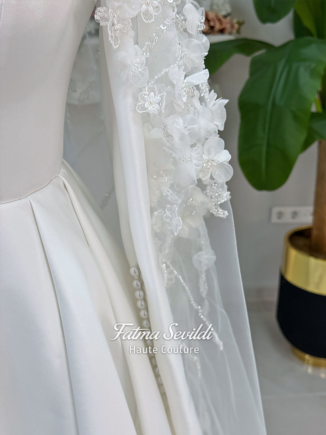Luxury hijab wedding dress with long sleeves and high neck in an elegant A-line silhouette, shown with premium lace veil. Modest bridal gown featuring subtle sparkle embroidery and a chapel train.