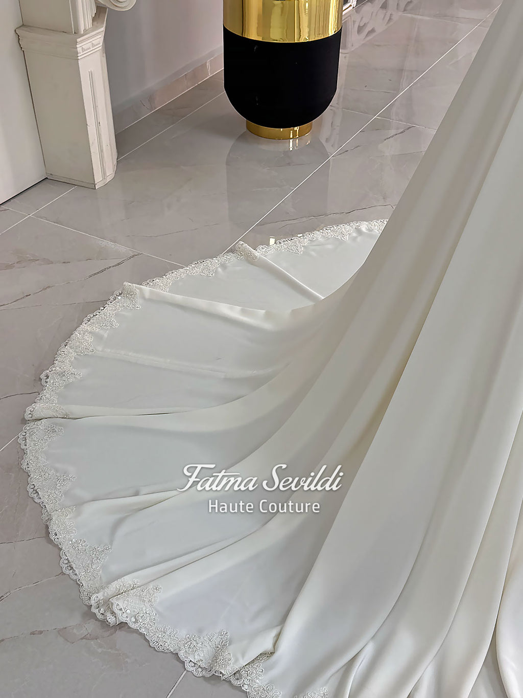 Ivory long sleeve hijab wedding dress with detachable lace-edged cape, floral beaded embroidery, high neckline and floor-length A-line modest bridal silhouette. Designed for Muslim brides seeking an elegant luxury wedding gown with full coverage.