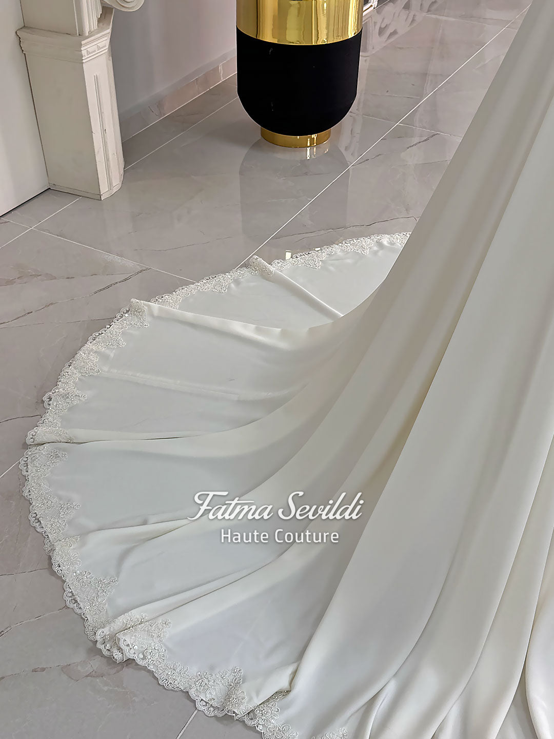 Ivory long sleeve hijab wedding dress with detachable lace-edged cape, floral beaded embroidery, high neckline and floor-length A-line modest bridal silhouette. Designed for Muslim brides seeking an elegant luxury wedding gown with full coverage.