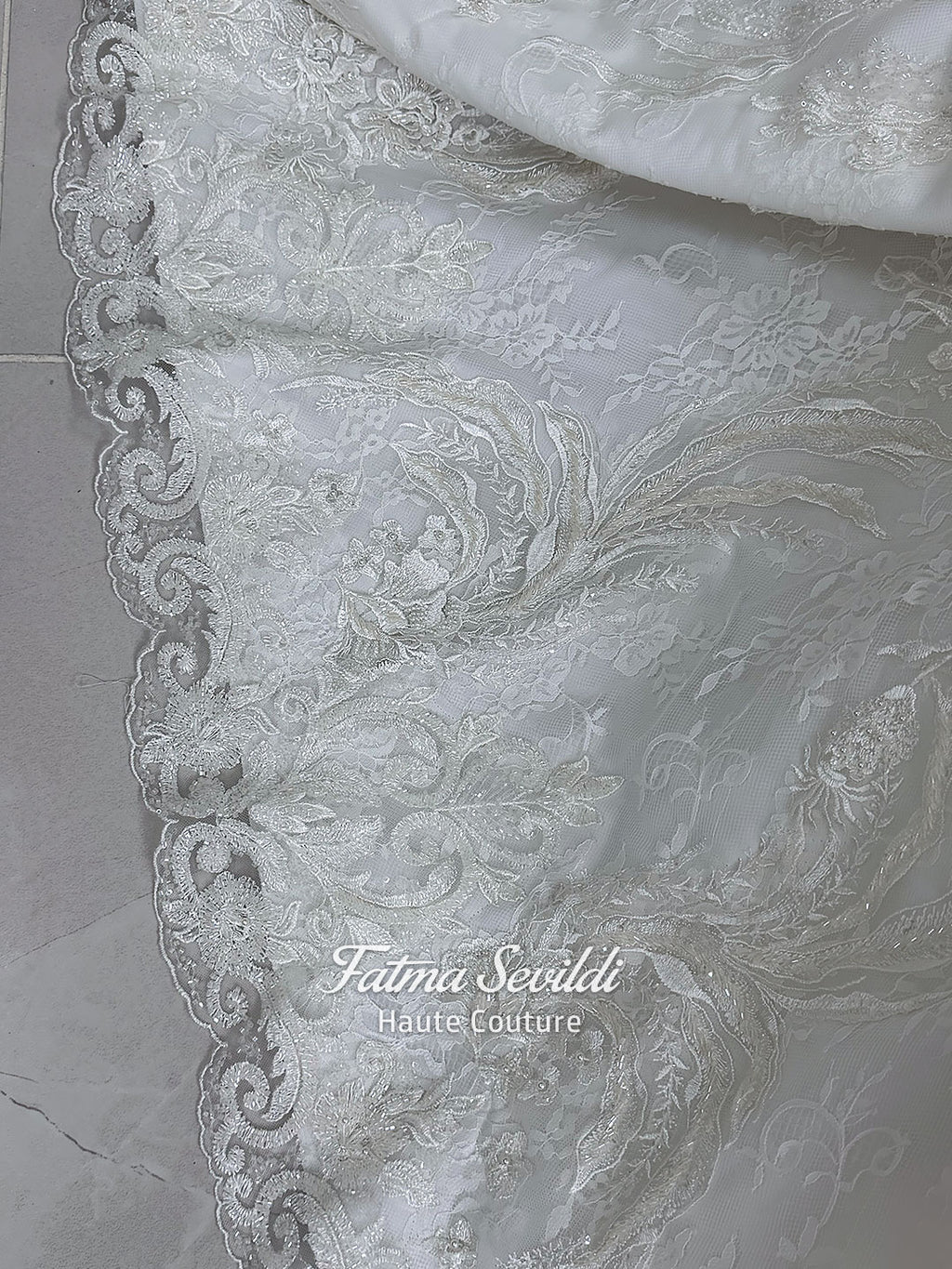 Ivory luxury hijab wedding dress featuring long lace sleeves, a high neckline, full beaded floral lace princess skirt, dramatic train and coordinating premium lace veil.