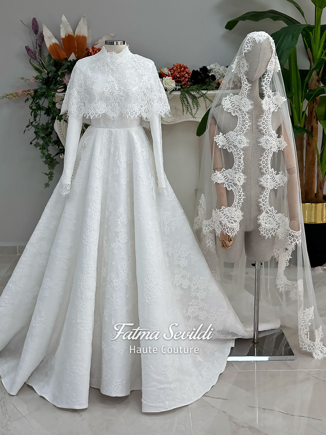 Elegant hijab wedding dress with long sleeves, high neck, detachable lace cape, cathedral train, and premium lace veil included. Luxury modest bridal couture gown in white with floral lace detailing.