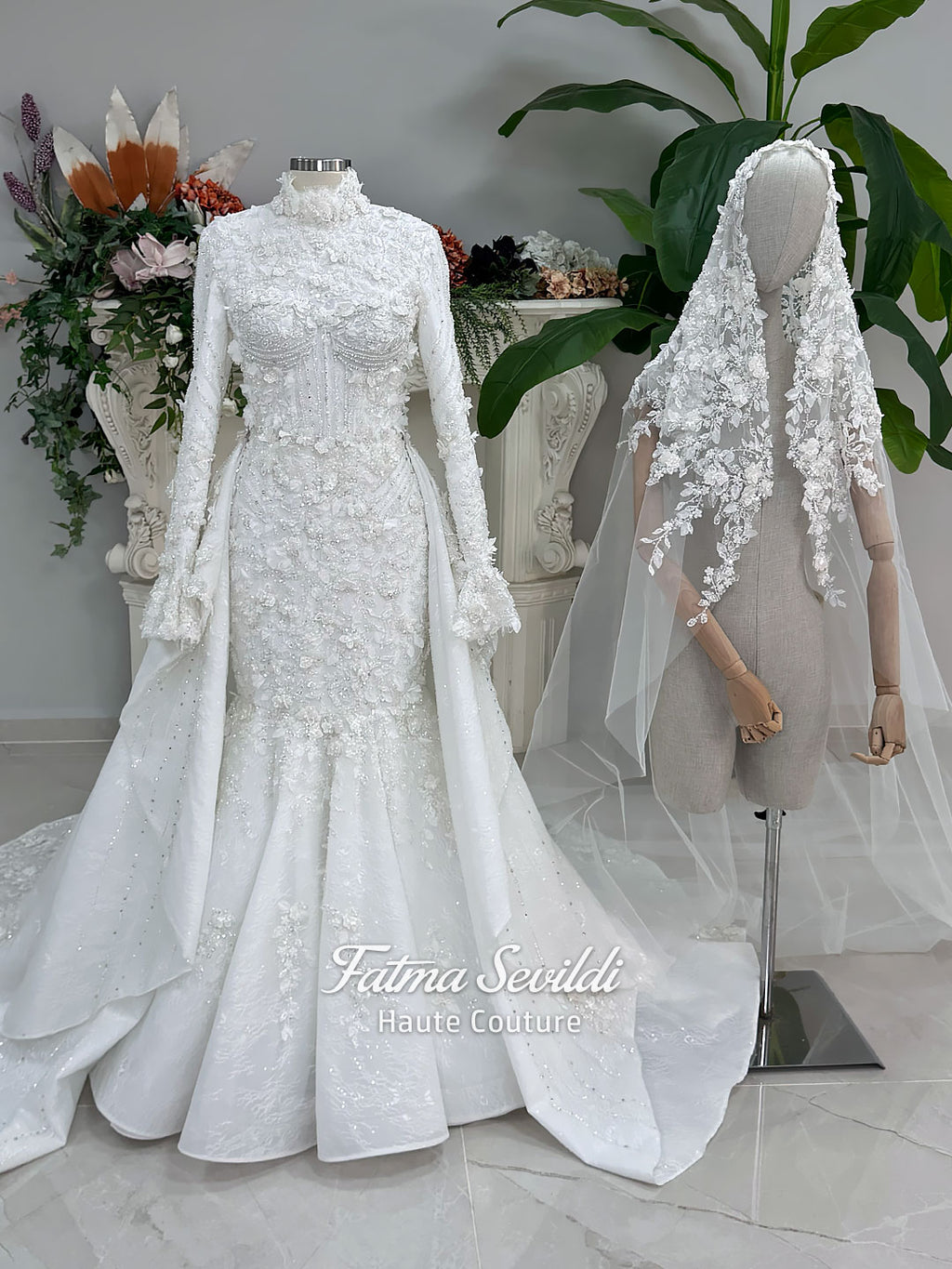 3-in-1 white hijab wedding dress with a beaded mermaid gown, detachable overskirt and long sleeve high-neck bridal topper. Convertible modest bridal set with dimensional floral lace and a coordinating lace veil.