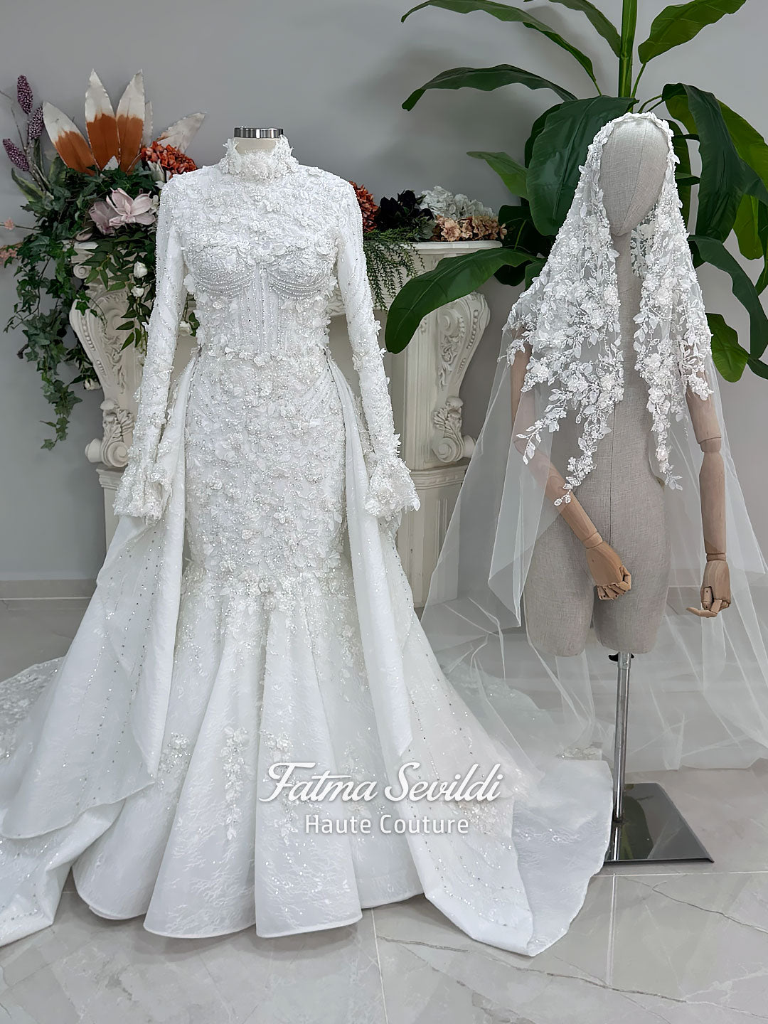 3-in-1 white hijab wedding dress with a beaded mermaid gown, detachable overskirt and long sleeve high-neck bridal topper. Convertible modest bridal set with dimensional floral lace and a coordinating lace veil.