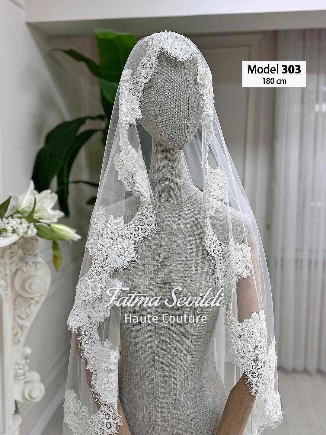 Delicate white lace cathedral veil with floral embroidery and mantilla frame