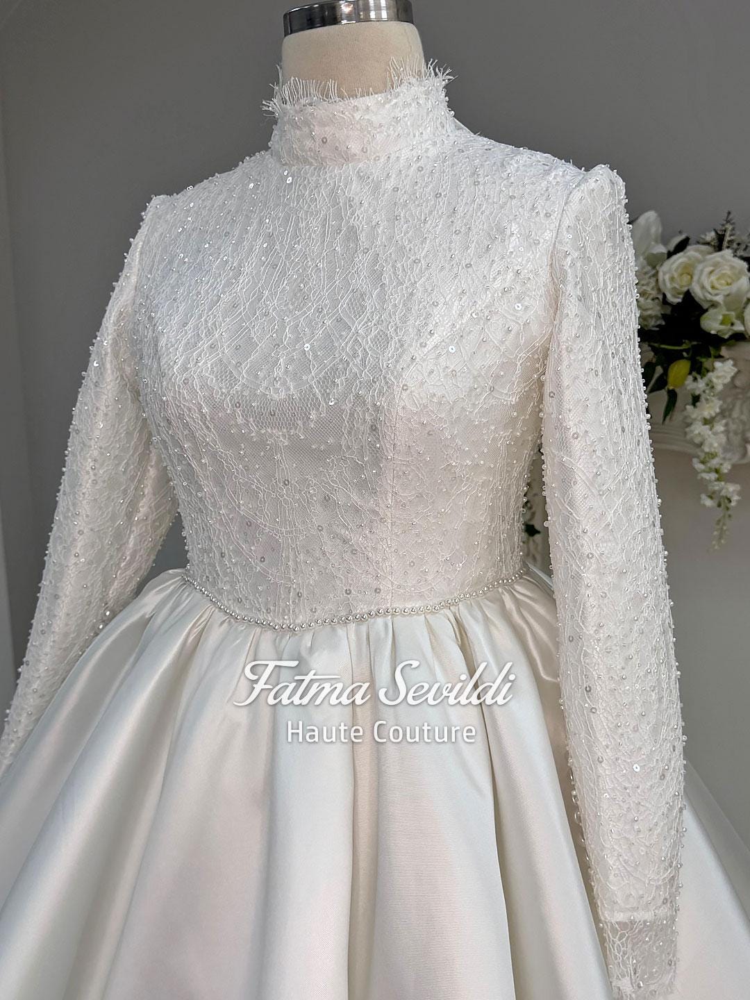 Elegant veiled hijab wedding dress with high-neck beaded lace bodice and satin ballgown skirt
