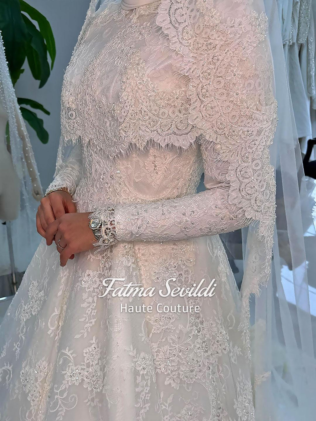 Delicate ivory lace wedding gown with veiled hijab capelet, long sleeves, high neck