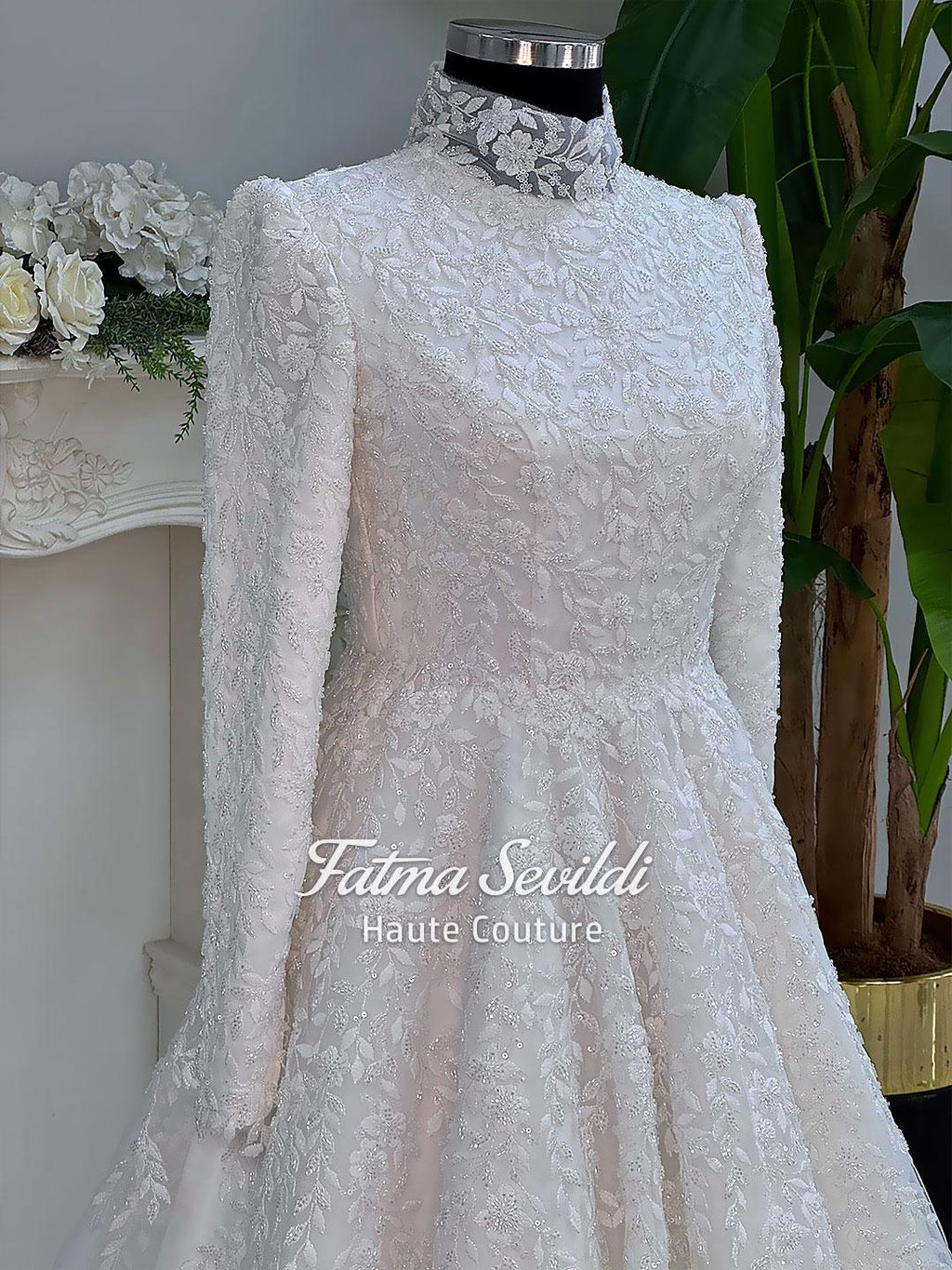 Elegant white lace A-line wedding gown with veiled hijab and high neckline