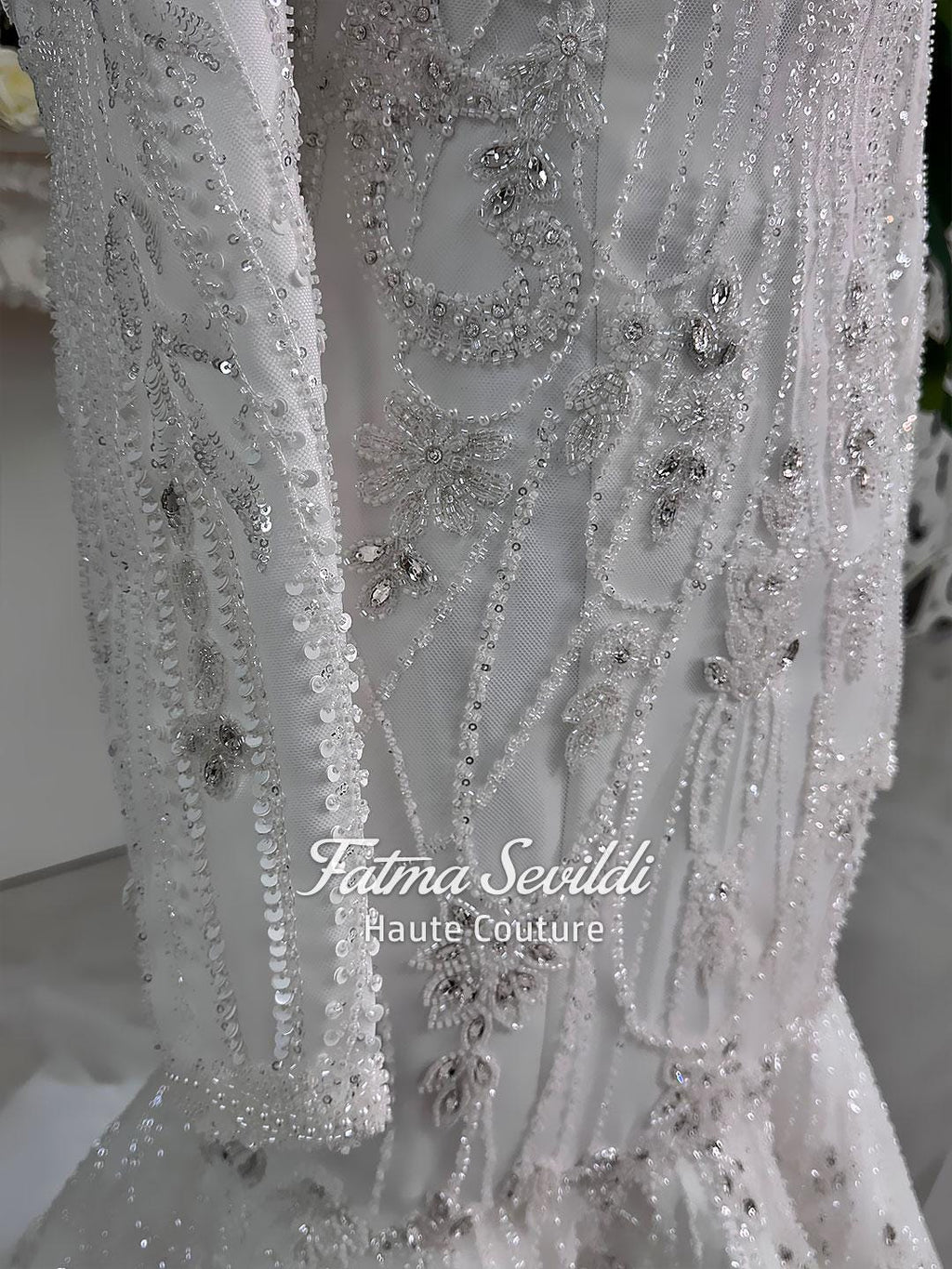 White beaded mermaid hijab wedding gown with silver floral patterns