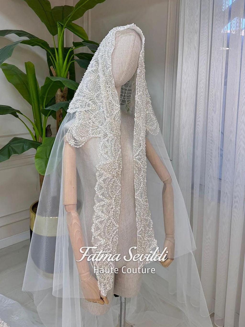 Delicate white lace veil with beading on mannequin, for Veiled Modest Wedding Dress