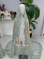 Sage green evening dress with beaded floral lace, a sweetheart neckline and long sleeves with flared lace cuffs, displayed on a mannequin.