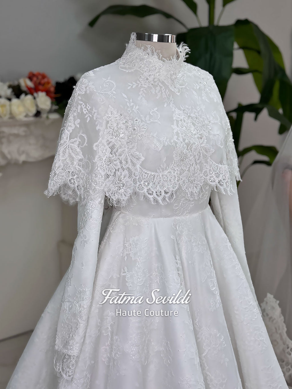 Elegant hijab wedding dress with long sleeves, high neck, detachable lace cape, cathedral train, and premium lace veil included. Luxury modest bridal couture gown in white with floral lace detailing.