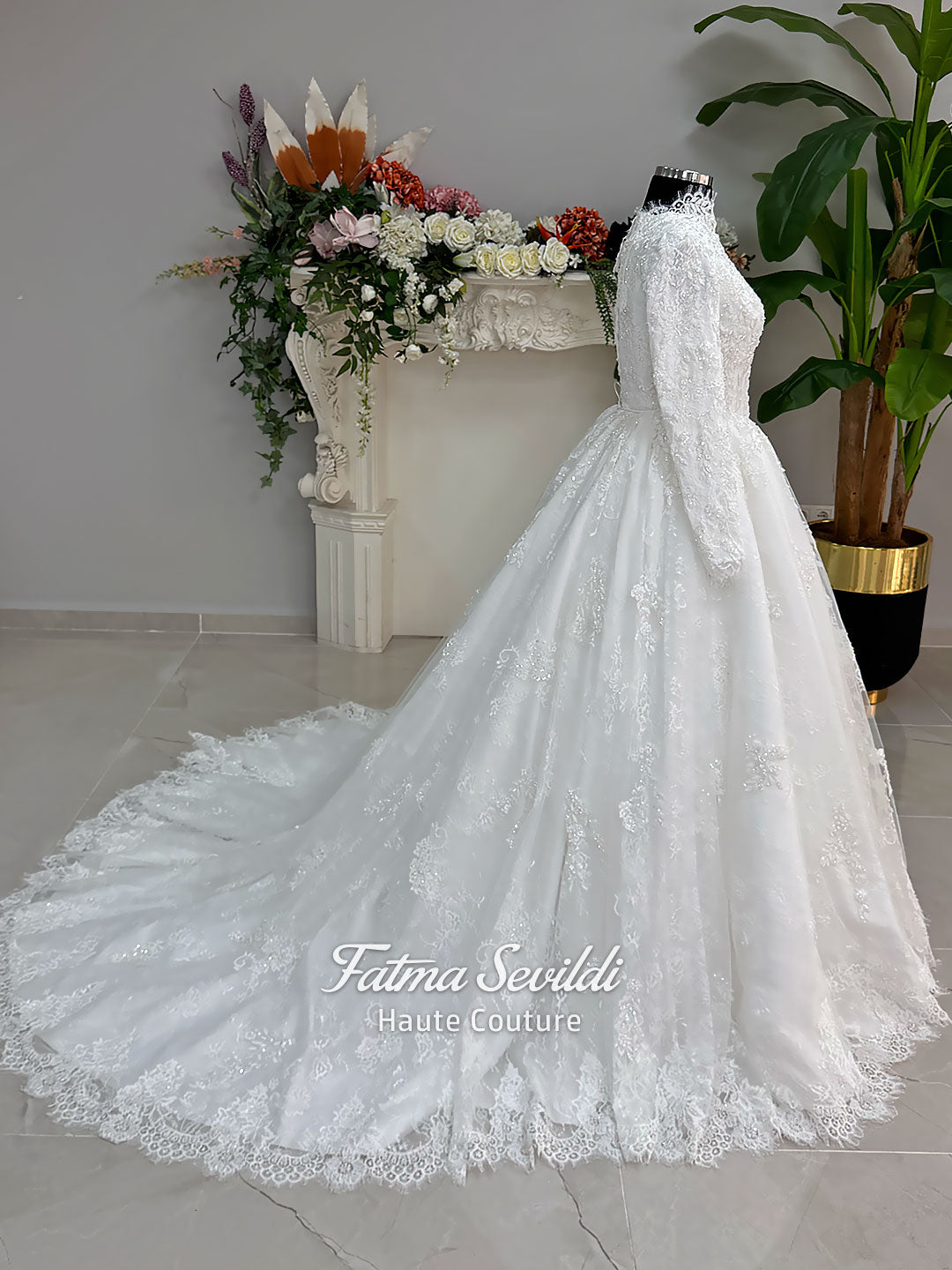Luxury modest hijab wedding dress ball gown with long sleeves, high neck corset bodice, lace appliqué and included lace veil, photographed in a bridal atelier.