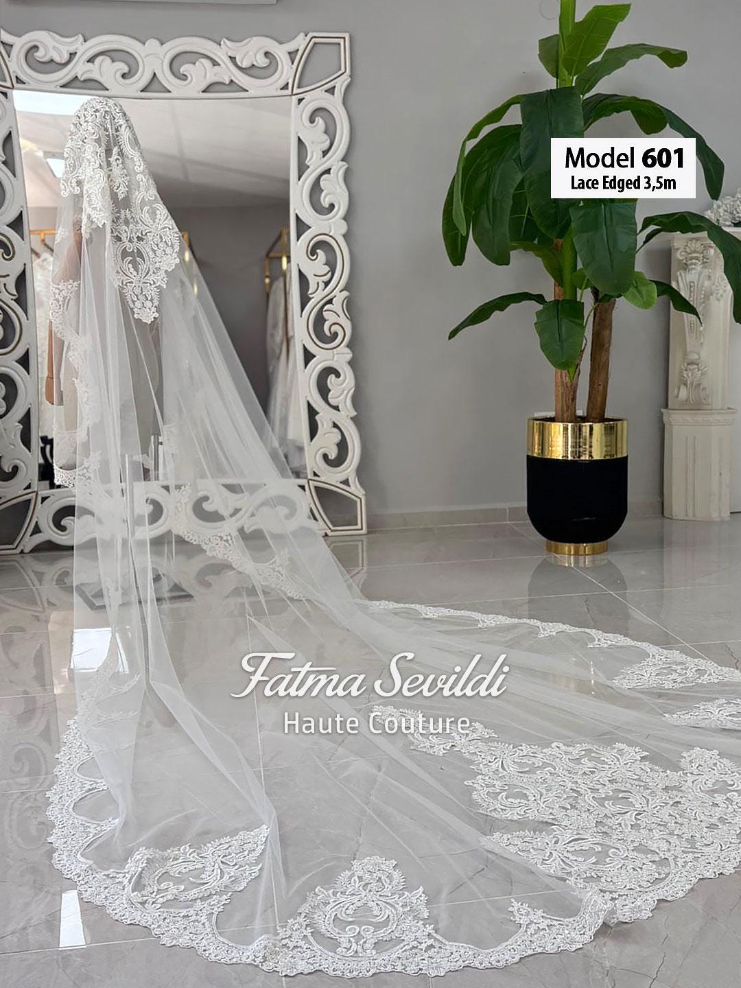 Delicate white lace-edged cathedral bridal veil with floral embroidery