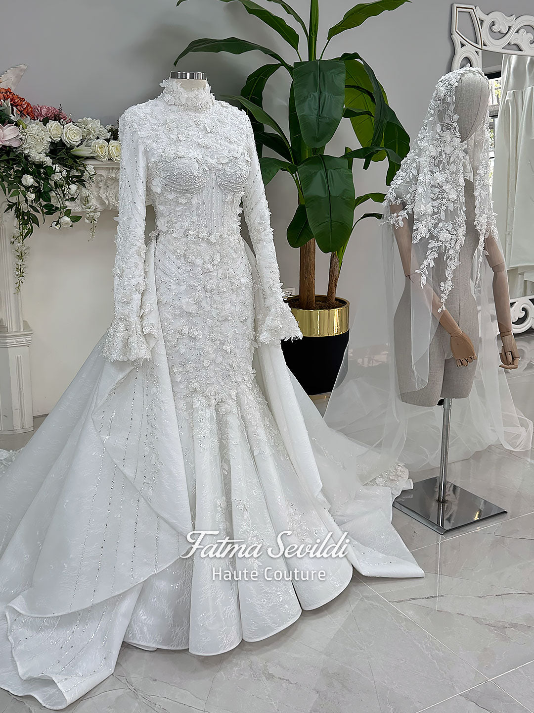 3-in-1 white hijab wedding dress with a beaded mermaid gown, detachable overskirt and long sleeve high-neck bridal topper. Convertible modest bridal set with dimensional floral lace and a coordinating lace veil.