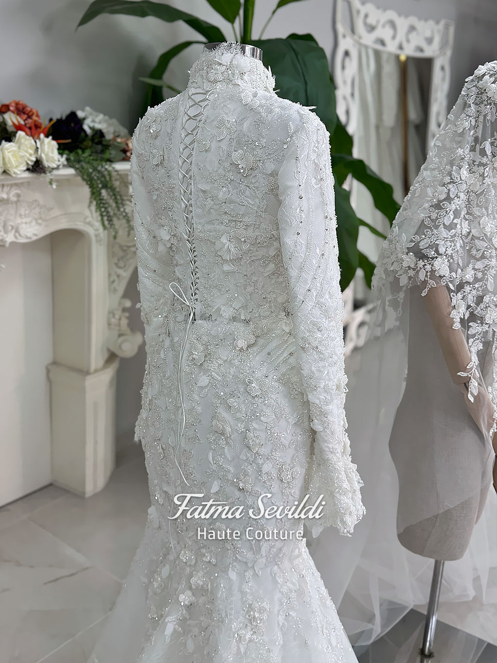 3-in-1 white hijab wedding dress with a beaded mermaid gown, detachable overskirt and long sleeve high-neck bridal topper. Convertible modest bridal set with dimensional floral lace and a coordinating lace veil.