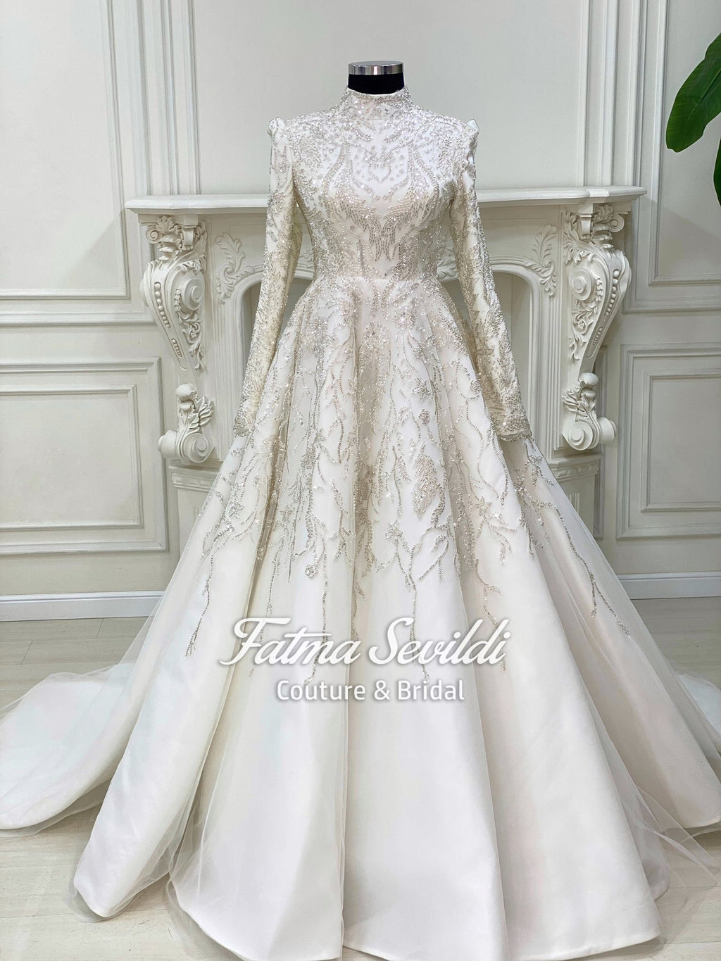 Elegant ivory hijab wedding gown with silver beading and long sleeves