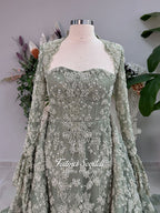 Sage green evening dress with beaded floral lace, a sweetheart neckline and long sleeves with flared lace cuffs, displayed on a mannequin.