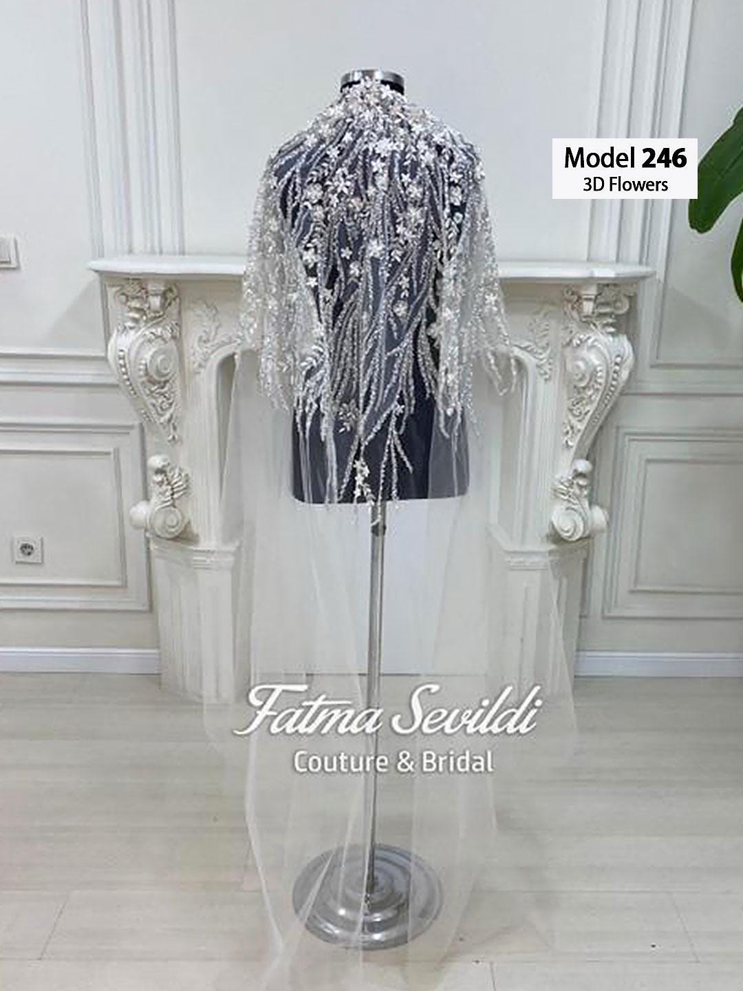 Elegant bridal gown with silver 3D floral embellishments and pearl lace veil