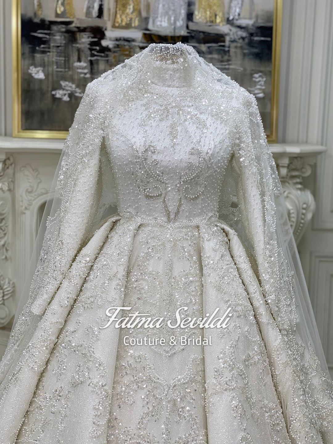 Luxurious ivory veiled modest wedding gown with beaded lace, high neck, long sleeves
