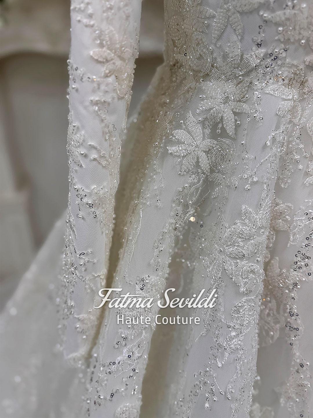 Delicate white lace veiled hijab wedding gown with silver beading