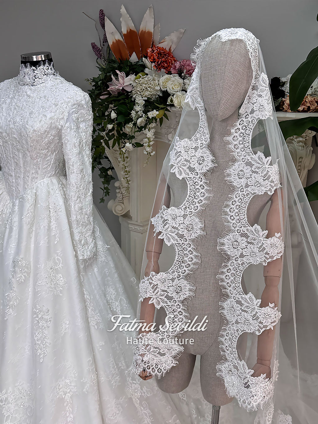 Luxury modest hijab wedding dress ball gown with long sleeves, high neck corset bodice, lace appliqué and included lace veil, photographed in a bridal atelier.