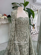 Sage green evening dress with beaded floral lace, a sweetheart neckline and long sleeves with flared lace cuffs, displayed on a mannequin.