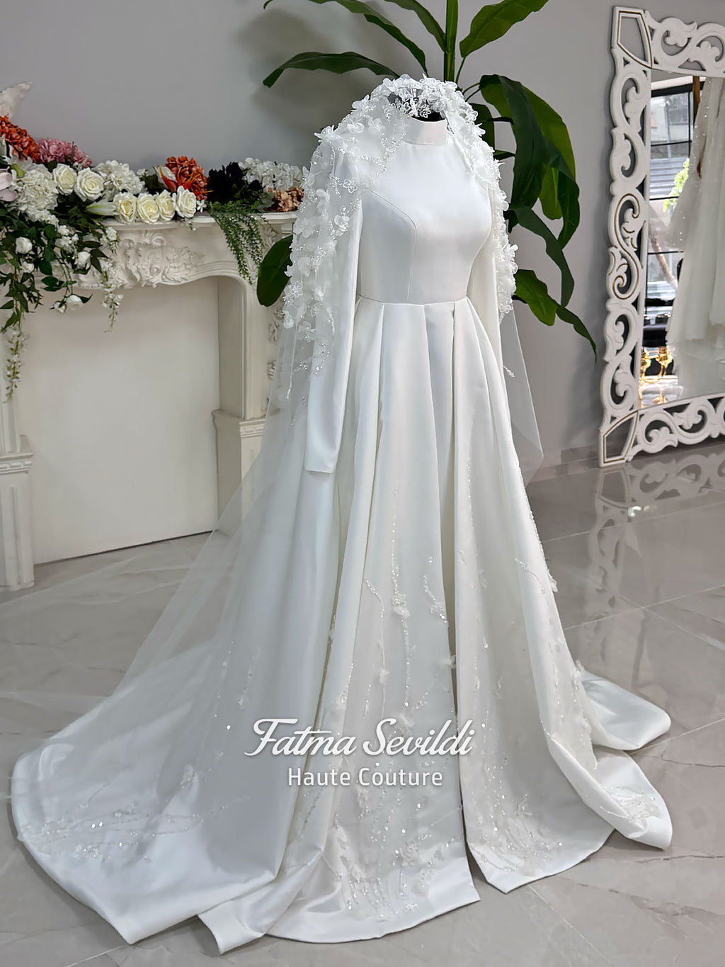Luxury hijab wedding dress with long sleeves and high neck in an elegant A-line silhouette, shown with premium lace veil. Modest bridal gown featuring subtle sparkle embroidery and a chapel train.