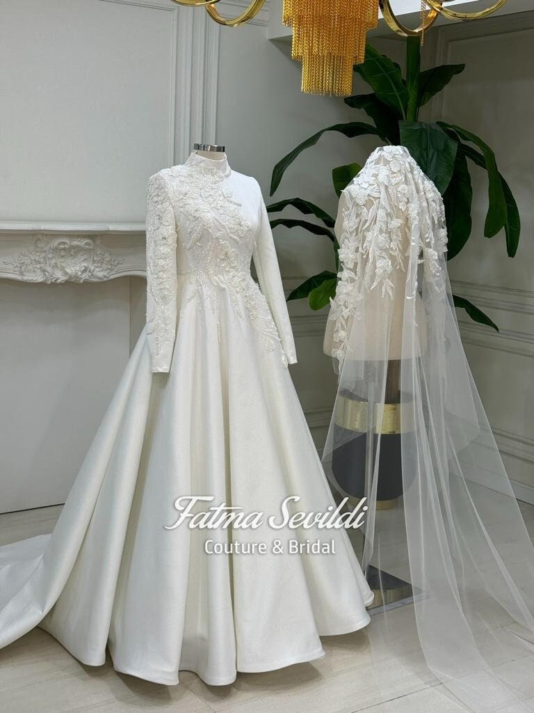 Elegant veiled satin hijab wedding gown with lace appliques and veil