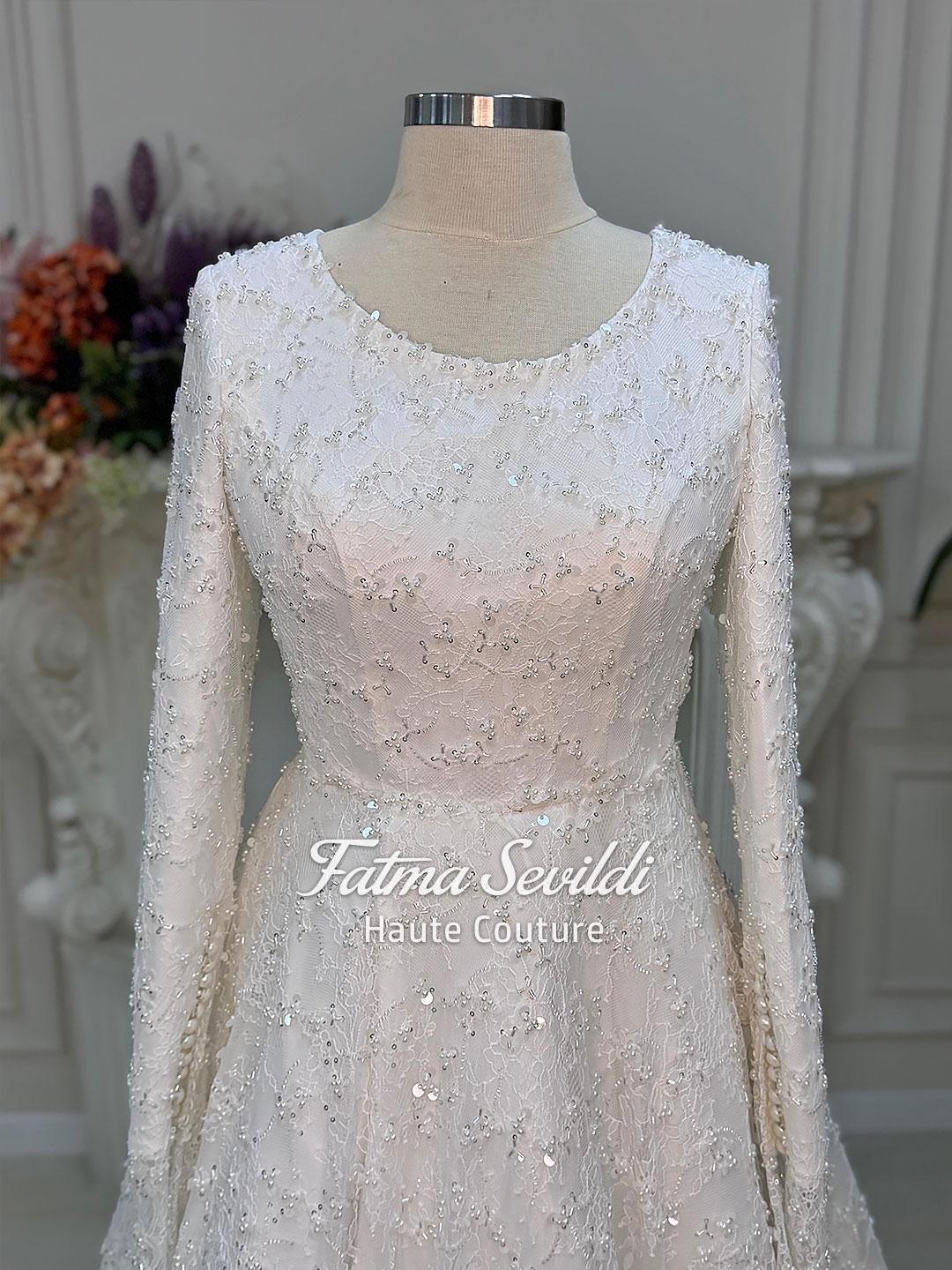 Veiled A-Line white lace wedding gown with full beaded long sleeves