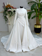 Luxury modest hijab wedding dress with long sleeves, 3D floral beaded lace bodice, draped satin A-line skirt and lace-edged veil included, shown on mannequin. Custom made Islamic bridal gown with elegant full coverage.