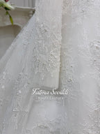 Delicate white lace sleeve with floral embroidery and pearl beads on elegant strapless wedding gown