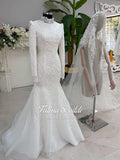 White mermaid wedding gown with long sleeves, high neck, beaded lace, and veiled hijab