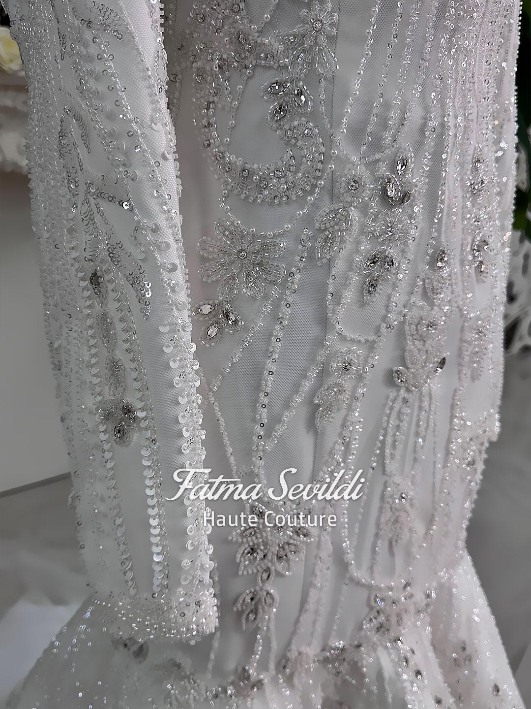 White beaded mermaid hijab wedding gown with silver floral patterns