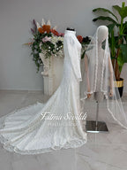 Luxury hijab wedding dress with long sleeves, high neck, beaded lace mermaid silhouette and detachable overskirt, veiled bridal set. Handmade couture modest bridal gown with lace-up corset back and sparkling embroidery.