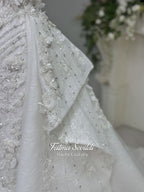 3-in-1 white hijab wedding dress with a beaded mermaid gown, detachable overskirt and long sleeve high-neck bridal topper. Convertible modest bridal set with dimensional floral lace and a coordinating lace veil.