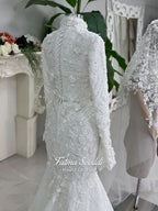 3-in-1 white hijab wedding dress with a beaded mermaid gown, detachable overskirt and long sleeve high-neck bridal topper. Convertible modest bridal set with dimensional floral lace and a coordinating lace veil.