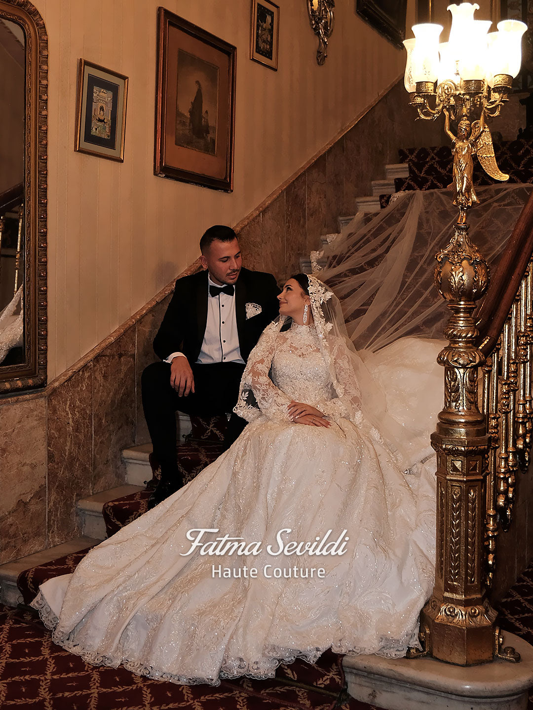Fatma Sevildi Couture lace wedding dress on a mannequin, featuring a high neckline, long sleeves and intricate floral embellishment.